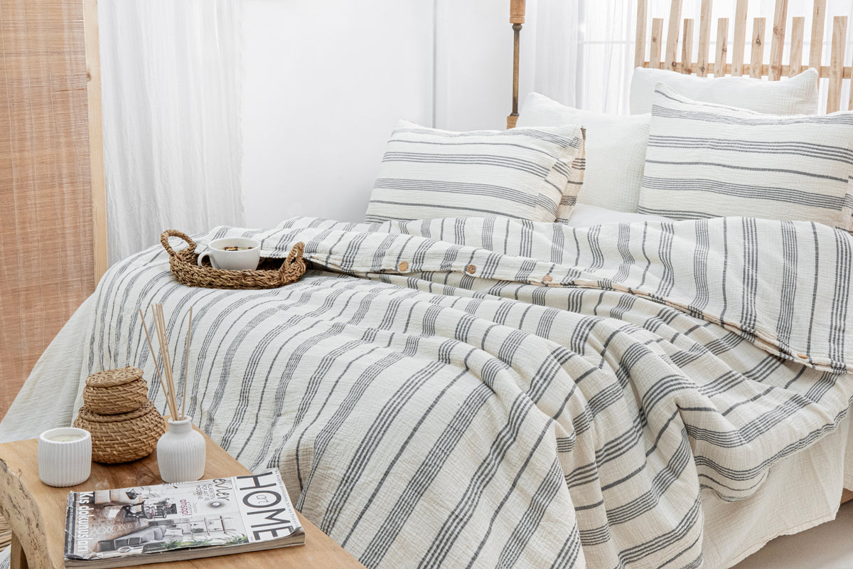 striped Naturloom cotton bedding arranged on a shared bed