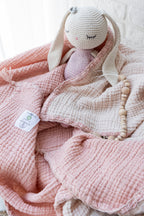 Pink organic muslin swaddle for nursery